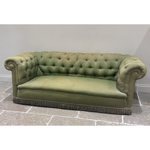 601 - A Victorian Chesterfield sofa, with button upholstered back in an all over green fabric, fringed, 21... 
