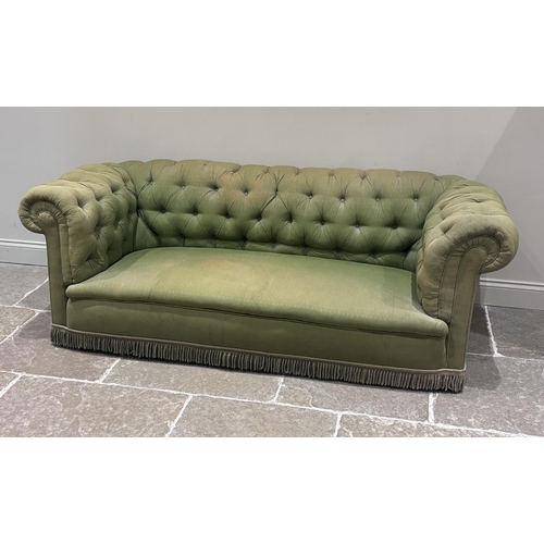 601 - A Victorian Chesterfield sofa, with button upholstered back in an all over green fabric, fringed, 21... 