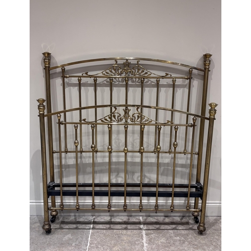 577 - An Art Nouveau lacquered brass double bed frame, the head and foot with spindle supports above an ar... 