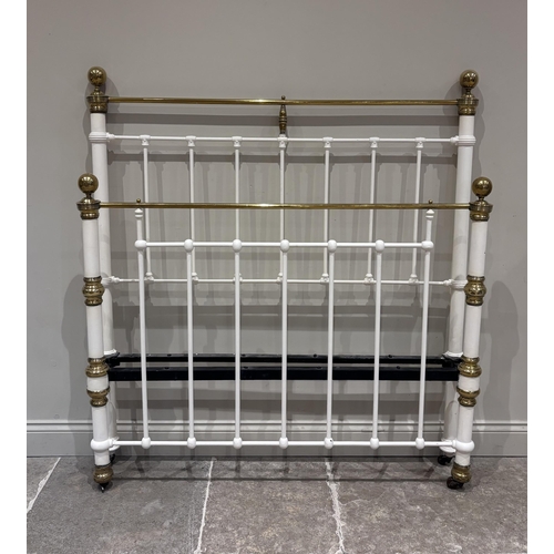 578 - A Victorian cast iron and lacquered brass double bed frame, cream painted and raised on castors, wit... 