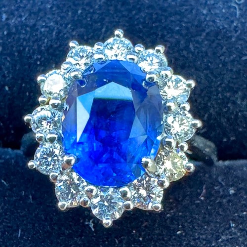 135 - A mid 20th century certified sapphire and diamond cluster ring, circa 1960, the oval sapphire within... 