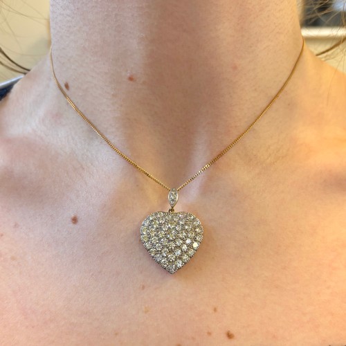 120 - A mid 20th century diamond heart pendant, the pendant set with forty six graduated round cut diamond... 