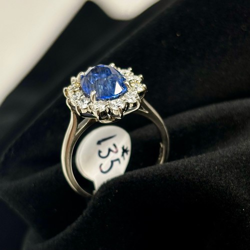 135 - A mid 20th century certified sapphire and diamond cluster ring, circa 1960, the oval sapphire within... 