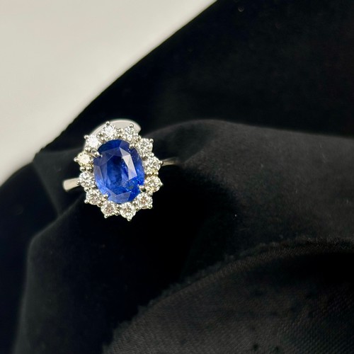 135 - A mid 20th century certified sapphire and diamond cluster ring, circa 1960, the oval sapphire within... 