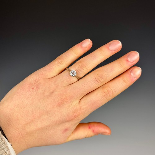 116 - An early 20th century diamond solitaire, the old cut diamond within white metal claw setting, leadin... 