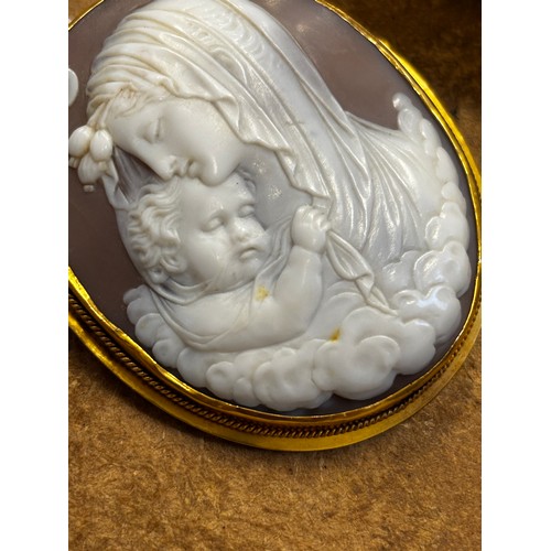 115 - A 19th century Italian cameo brooch, the central oval depiction of the Madonna with child, within a ... 