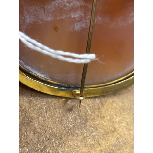 115 - A 19th century Italian cameo brooch, the central oval depiction of the Madonna with child, within a ... 