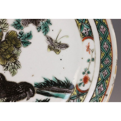 339 - A Chinese porcelain famille verte saucer dish, 18th century, the small circular dish painted to the ... 