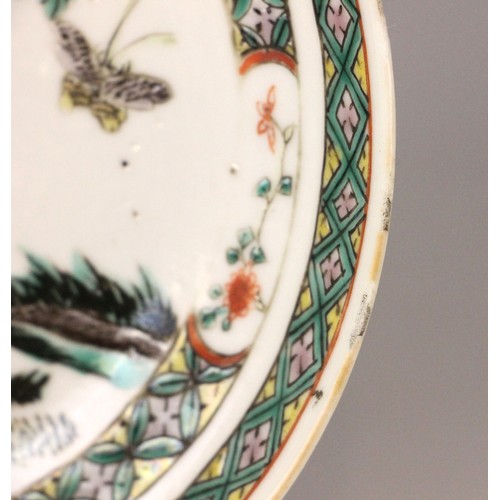 339 - A Chinese porcelain famille verte saucer dish, 18th century, the small circular dish painted to the ... 