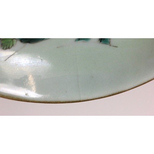 348 - A Chinese celadon-ground famille rose dish, 19th century, of circular form and panted to the centre ... 