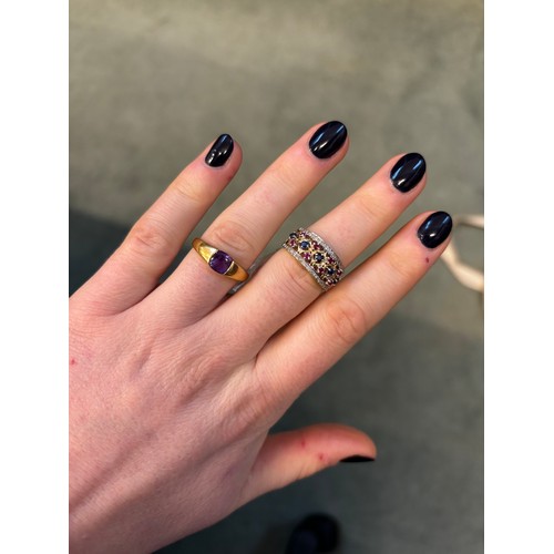 133 - A 9ct gold amethyst dress ring, the tension set amethyst within tapering yellow metal shank, import ... 