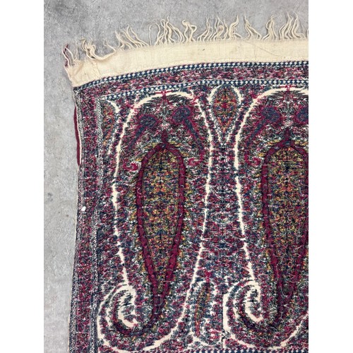 398 - A 19th century finely woven Kashmir style paisley shawl, in ivory with a paisley pattern border, fri... 