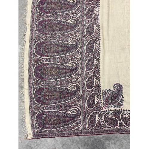398 - A 19th century finely woven Kashmir style paisley shawl, in ivory with a paisley pattern border, fri... 