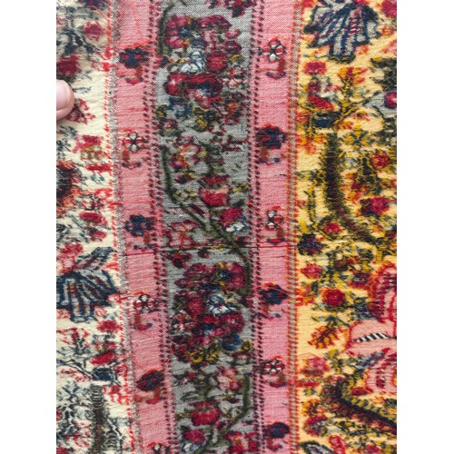 399 - A 19th century finely woven Kashmir style shawl, the ivory ground with delicate foliate borders and ... 