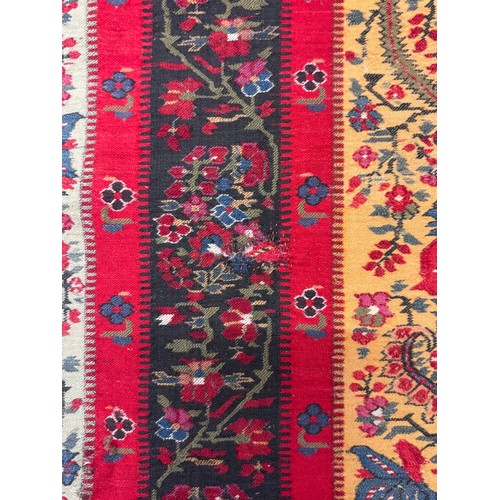 399 - A 19th century finely woven Kashmir style shawl, the ivory ground with delicate foliate borders and ... 