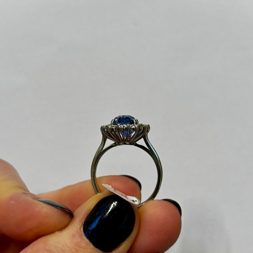135 - A mid 20th century certified sapphire and diamond cluster ring, circa 1960, the oval sapphire within... 