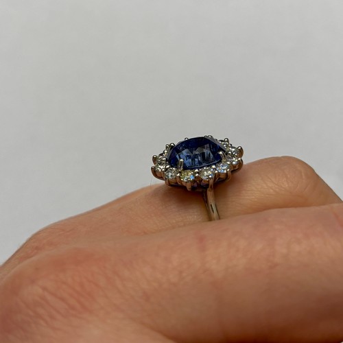 135 - A mid 20th century certified sapphire and diamond cluster ring, circa 1960, the oval sapphire within... 