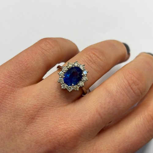 135 - A mid 20th century certified sapphire and diamond cluster ring, circa 1960, the oval sapphire within... 