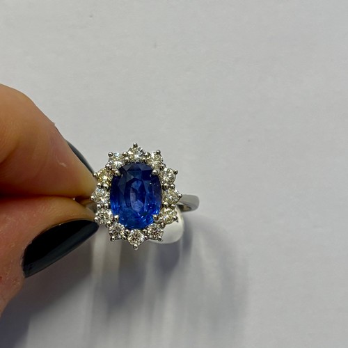 135 - A mid 20th century certified sapphire and diamond cluster ring, circa 1960, the oval sapphire within... 