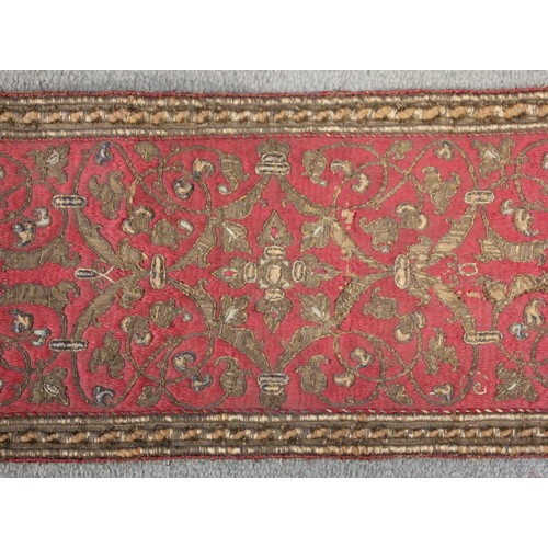 405 - A 19th century green silk damask and metallic edged apron, on yellow fabric backing, 116cm long, wit... 