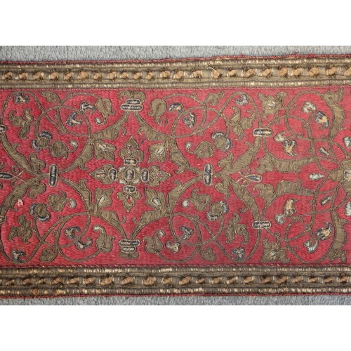 405 - A 19th century green silk damask and metallic edged apron, on yellow fabric backing, 116cm long, wit... 