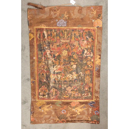 415 - A South East Asian Tibetan Thangka, 19th century, painted in gouache against a silk and metallic gro... 