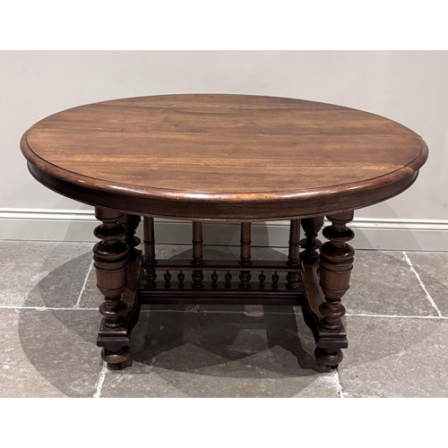 A French walnut extending dining table, 19h century, the oval top ...