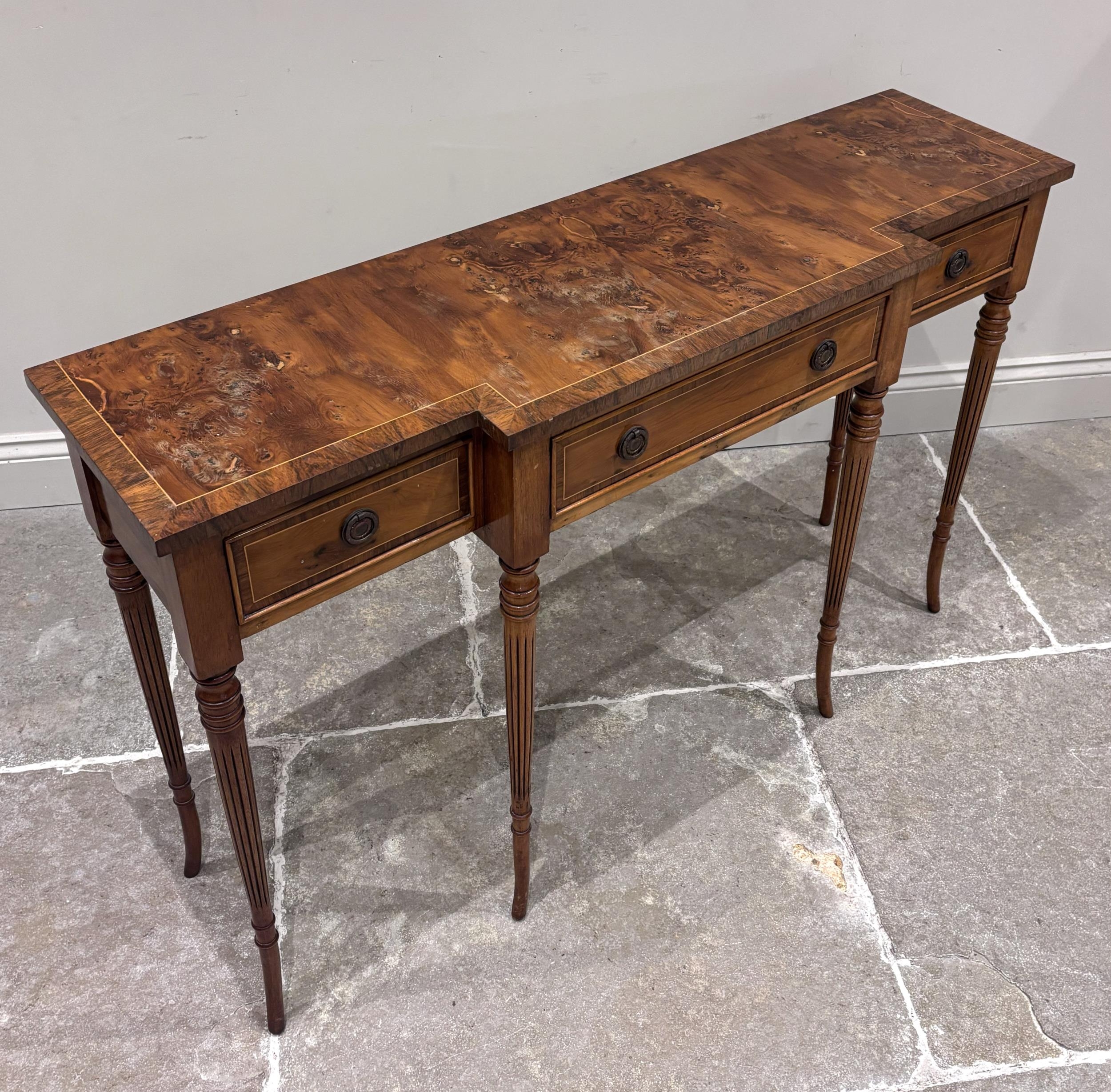 A Regency style burr wood console table, the breakfront with a central ...