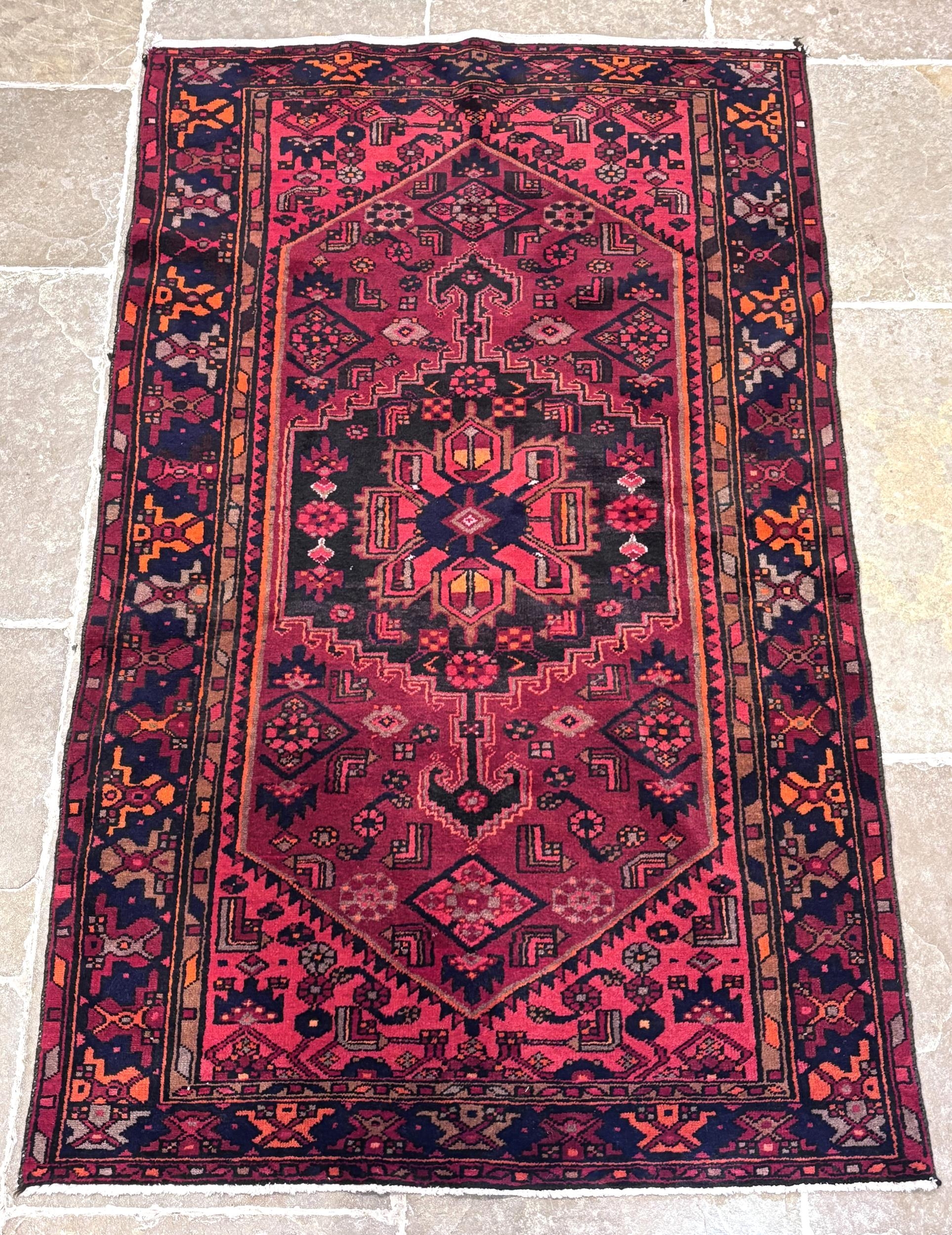 A hand knotted Persian Hamadan wool rug, with a central medallion ...