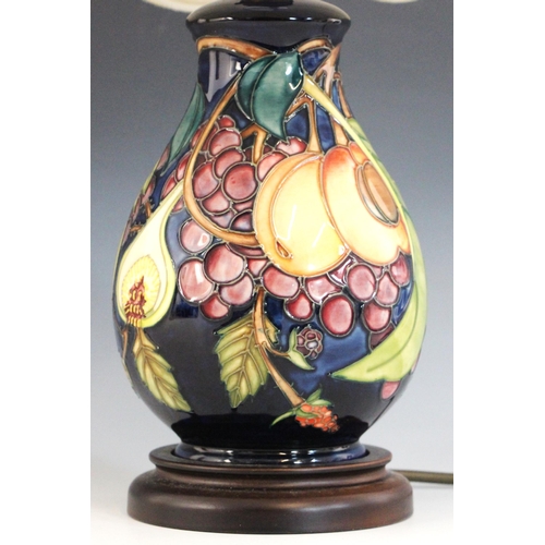 391 - A Moorcroft table lamp in the 'Queens Choice' patterned designed by Emma Bossons, of baluster form, ... 