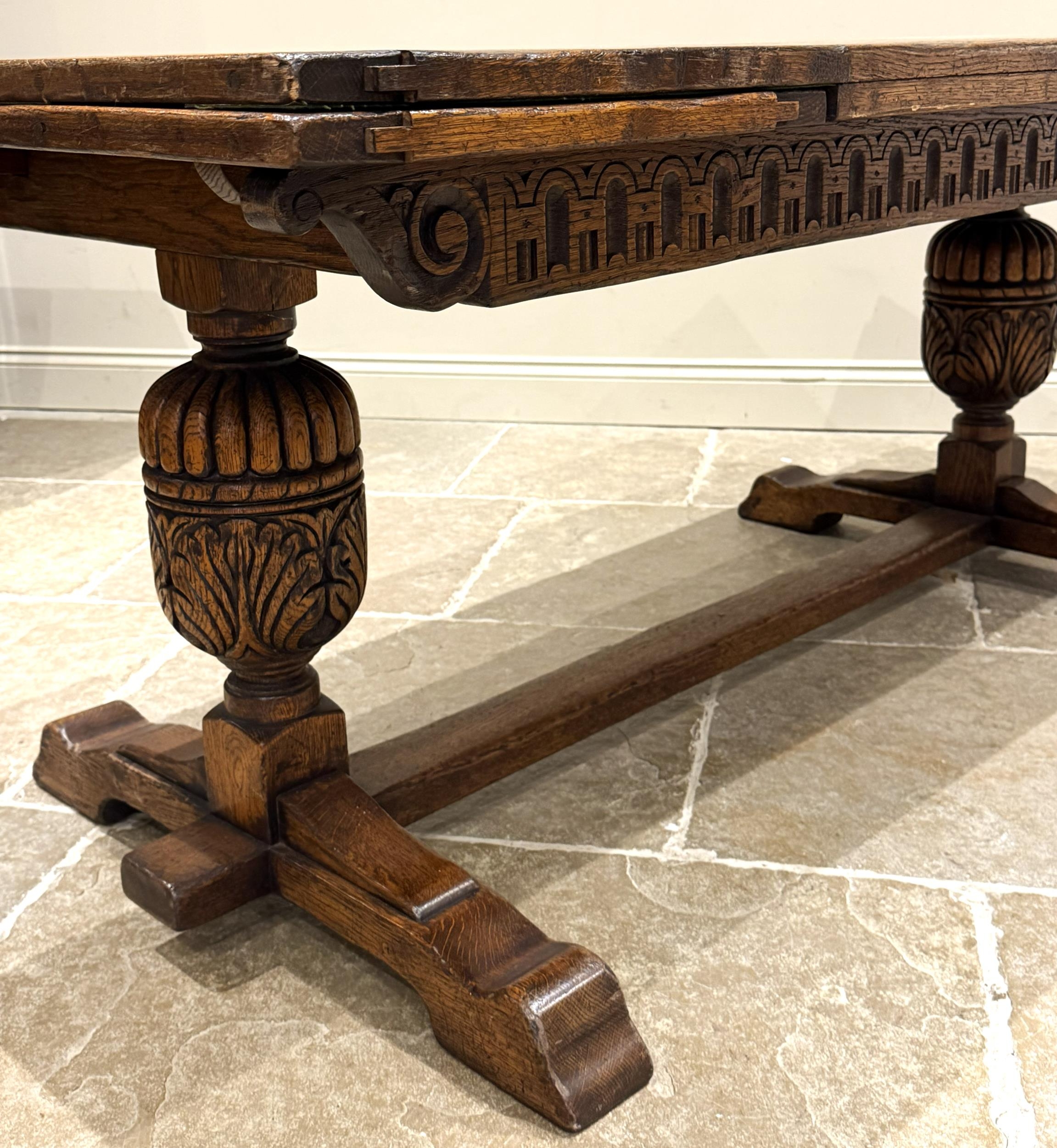 An oak extending refectory table in Carolean style, the three plank top ...