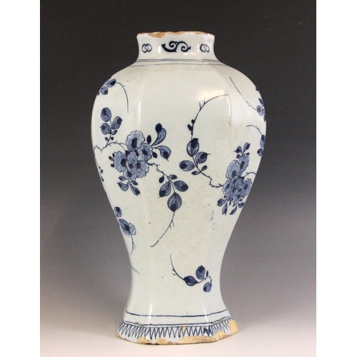 438 - An 18th century blue and white Delft vase, the high shouldered vase of octagonal baluster form exter... 