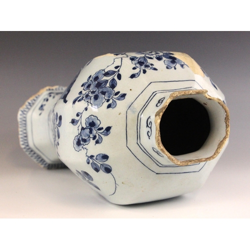 438 - An 18th century blue and white Delft vase, the high shouldered vase of octagonal baluster form exter... 