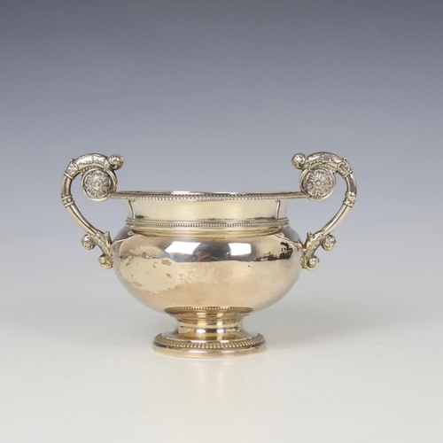 82 - A late 19th century white metal twin handled bowl, possibly Danish, the twin florally cast handles a... 