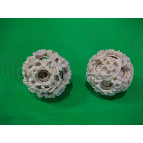 263 - TWO IVORY CARED ORIENTAL PUZZLE BALLS