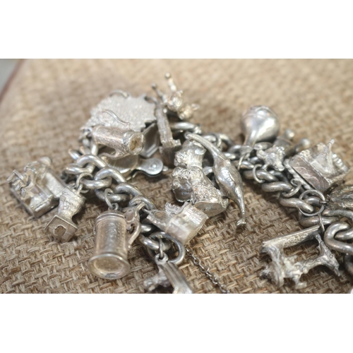 409 - SILVER HALL MARKED CHARM BRACELET - 21 CHARMS WITH SPECIALS - OPENING WEDDING CAKE/TANKARD/ARK/VICTO... 