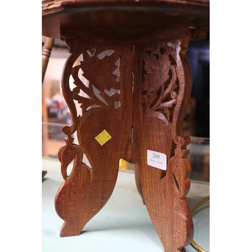 369 - SMALL ORNATELY CARVED TABLE WITH INLAID SHELKF