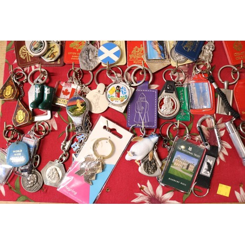 421 - Board full of keyrings (approx 65)