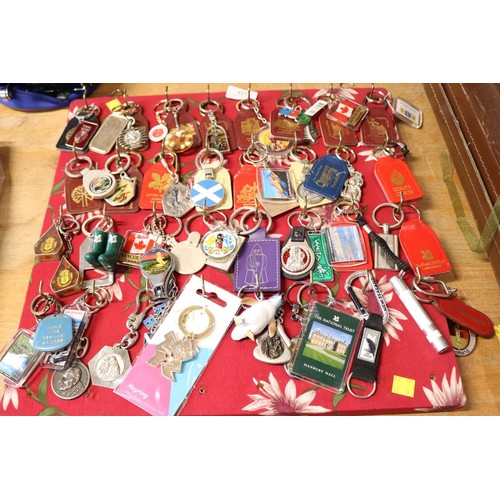 421 - Board full of keyrings (approx 65)