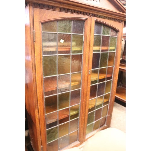 683 - Oak bookcase with leaded stained glass doors & arch pediment
