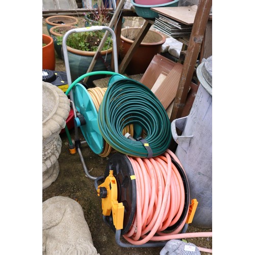 61 - 2 hose pipes & reels & a flat hose pipe