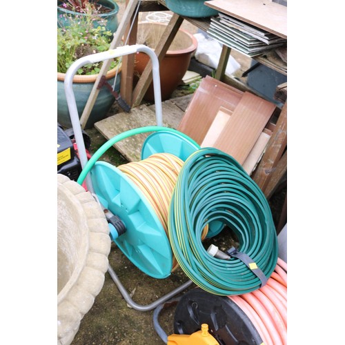 61 - 2 hose pipes & reels & a flat hose pipe