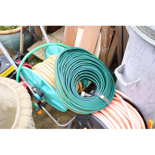 61 - 2 hose pipes & reels & a flat hose pipe