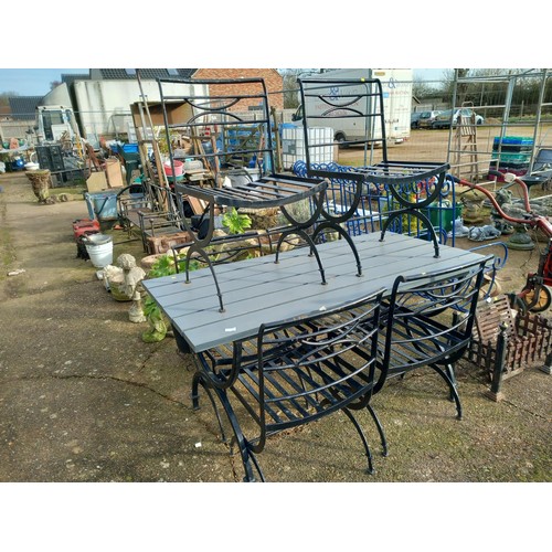 63 - Wrought iron table, wooden top & 6 chairs