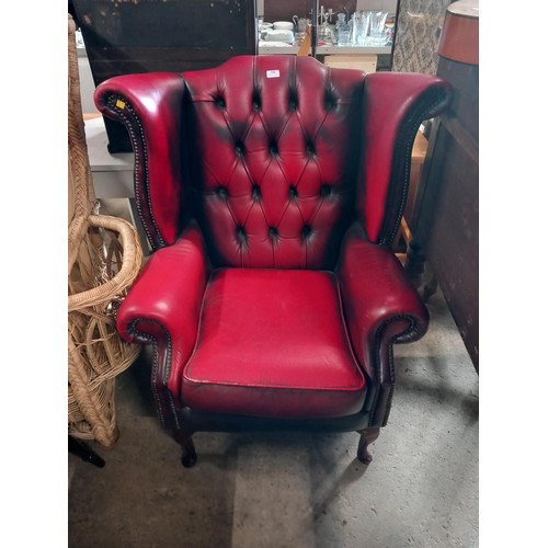 588 - Red leather wing back chair