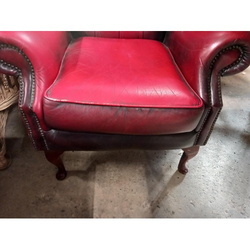 588 - Red leather wing back chair