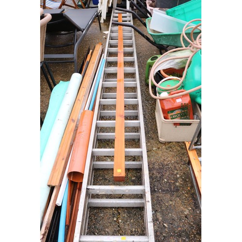 63 - Large double aluminium D wrong extension ladder & piece of timber