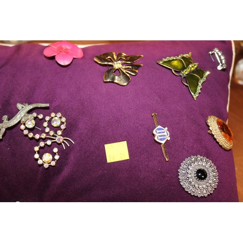 433 - Cushion of various brooches