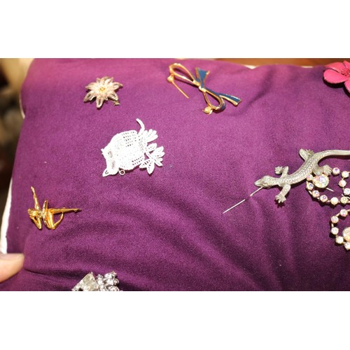 433 - Cushion of various brooches