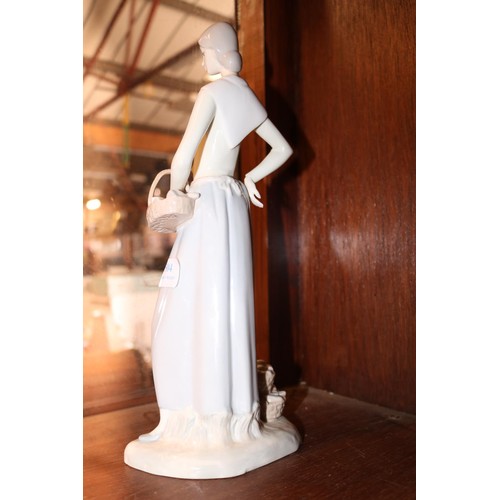 504 - Lladro style lady with fish baskets